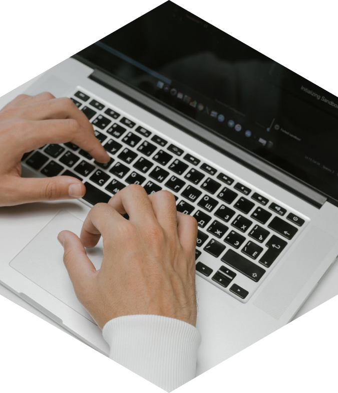 man typing on a laptop
